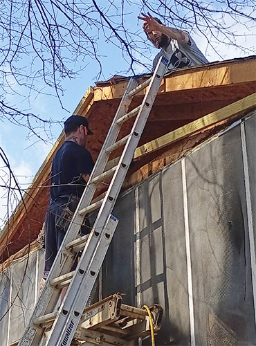 Jobsite picture of men in recovery working on a home